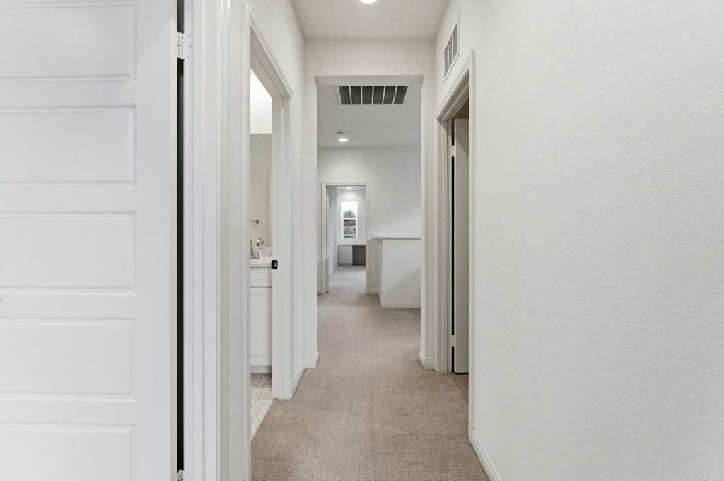 2711 Jujube Street Spring Valley, CA 91977 - Photo 17 of 31 a view of a hallway with wooden shelves