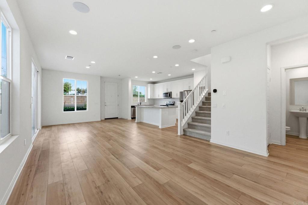 2711 Jujube Street Spring Valley, CA 91977 - Photo 6 of 31 a view of a living room with wooden floors and kitchen view