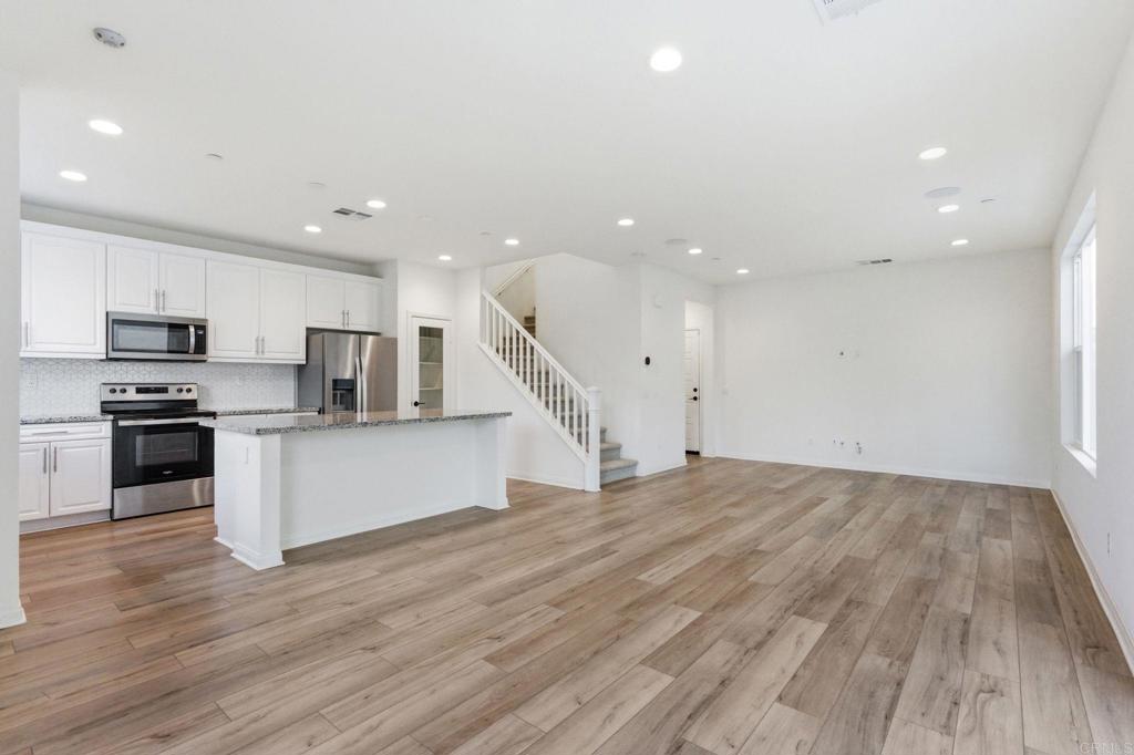 2711 Jujube Street Spring Valley, CA 91977 - Photo 7 of 31 a view of kitchen with wooden floor and electronic appliances