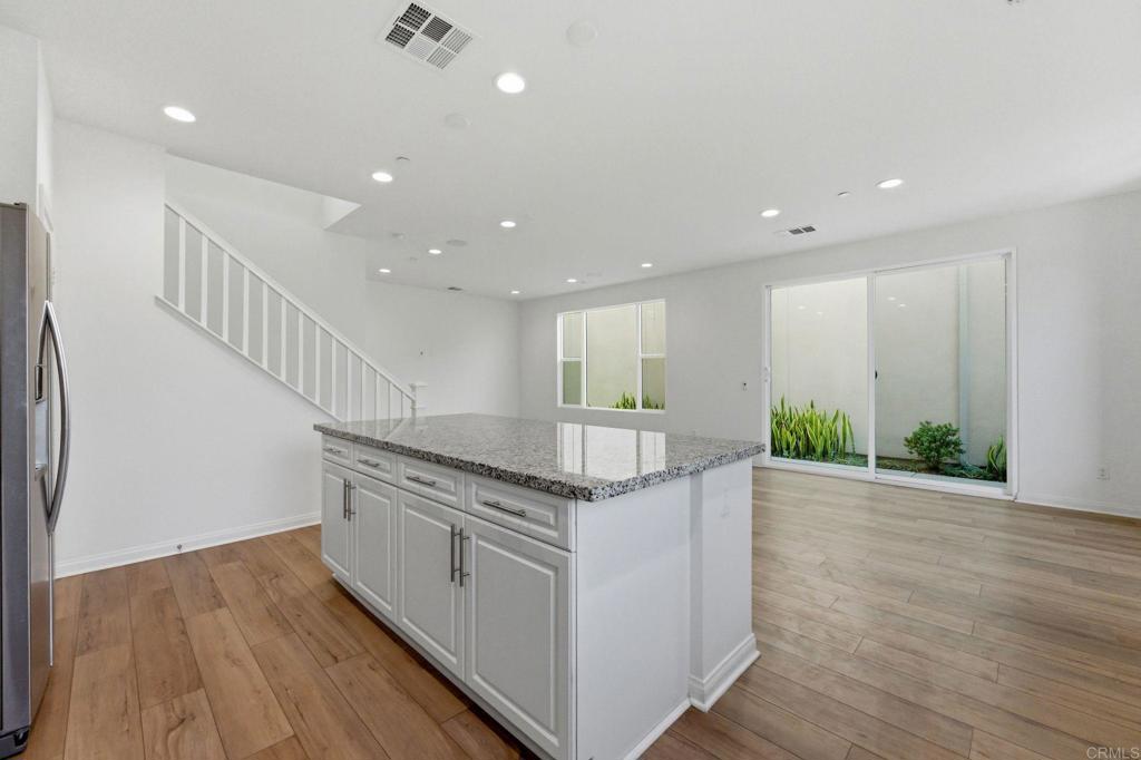 2711 Jujube Street Spring Valley, CA 91977 - Photo 8 of 31 a kitchen with stainless steel appliances granite countertop a table and a sink