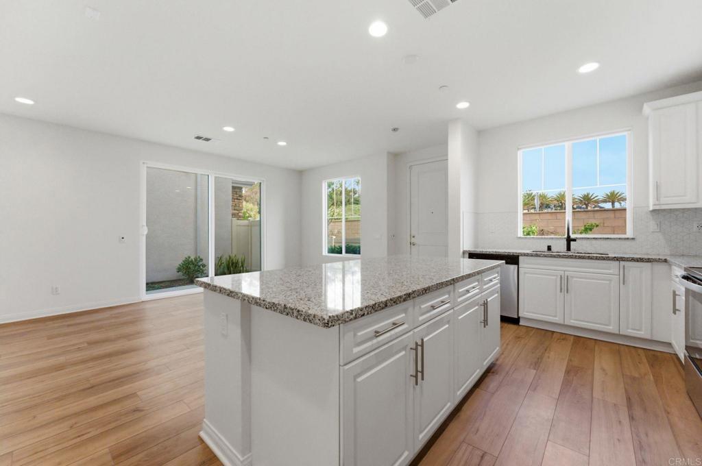 2711 Jujube Street Spring Valley, CA 91977 - Photo 10 of 31 a kitchen with stainless steel appliances granite countertop a stove and a wooden floors