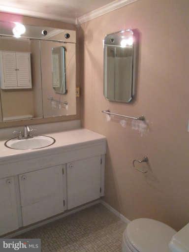 2624 Fort Farnsworth Road, Unit 209 Alexandria, VA 22303 - Photo 18 of 19 a bathroom with a toilet sink and mirror