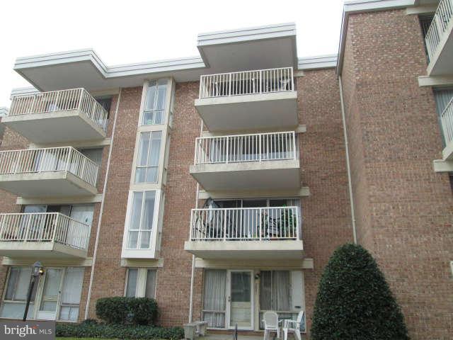 2624 Fort Farnsworth Road, Unit 209 Alexandria, VA 22303 - Photo 19 of 19 a front view of a residential apartment building with a yard