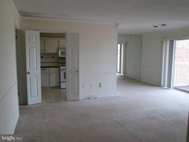 2624 Fort Farnsworth Road, Unit 209 Alexandria, VA 22303 - Photo 5 of 19 a view of a kitchen with a sink and a refrigerator