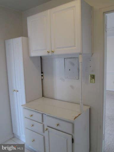 2624 Fort Farnsworth Road, Unit 209 Alexandria, VA 22303 - Photo 10 of 19 a kitchen with a white cabinets and a stove top oven