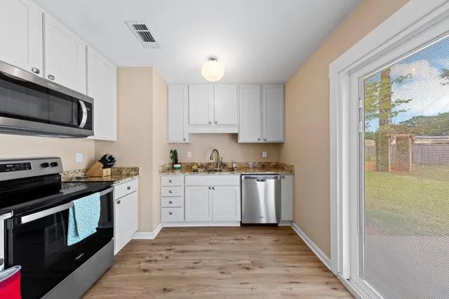 a kitchen with stainless steel appliances a refrigerator stove and microwave