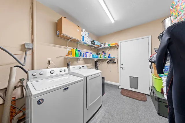 a backyard with a table and chairs and potted plants