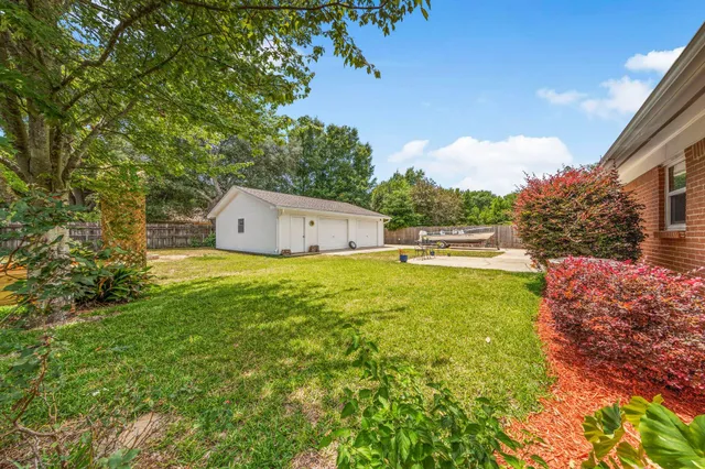 a front view of a house with a garden and yard