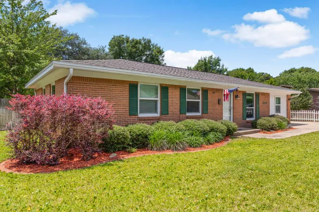 a front view of house with yard and green space