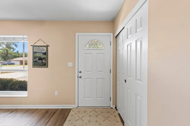 a view of an entryway with wooden floor