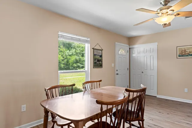 a view of a dining room with furniture window and wooden floor