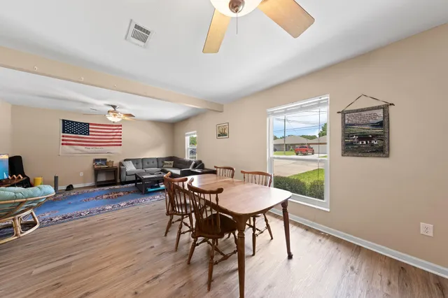 a view of a dining room with furniture and wooden floor