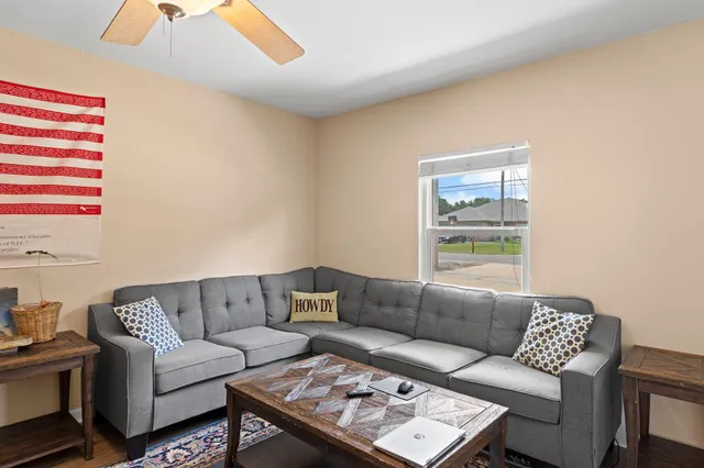 a living room with a couch and a window