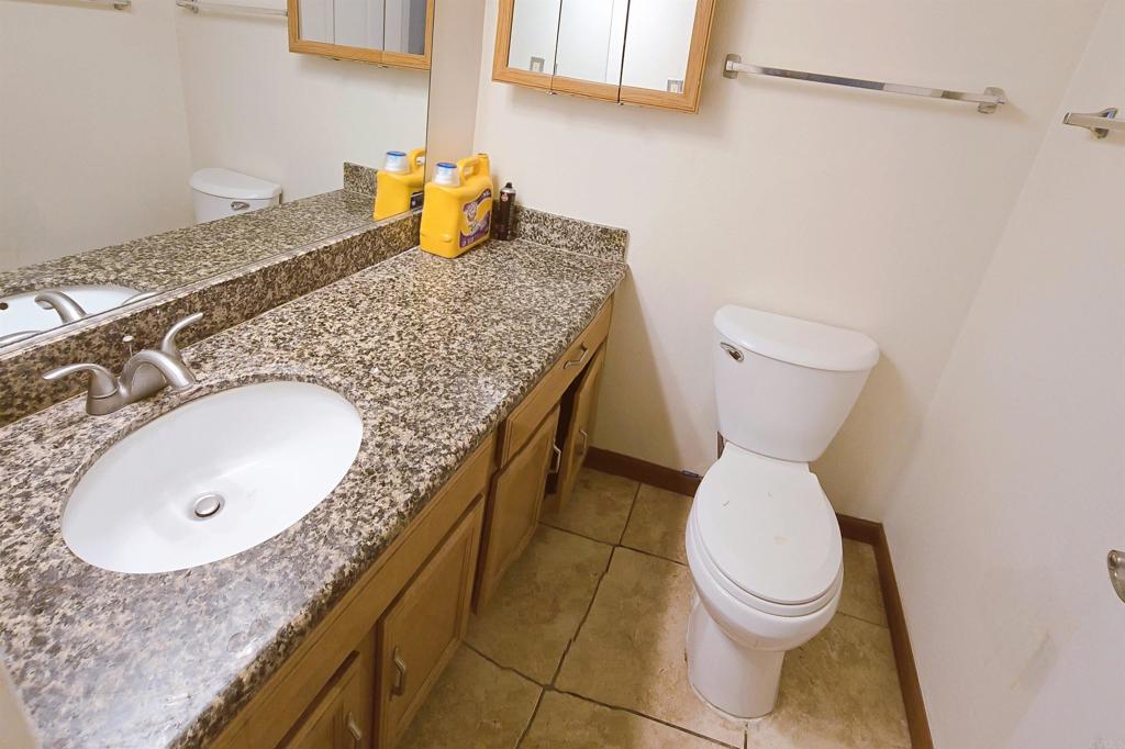 505 East Madison Avenue, Unit 70 El Cajon, CA 92020 - Photo 6 of 13 a bathroom with a granite countertop sink and toilet