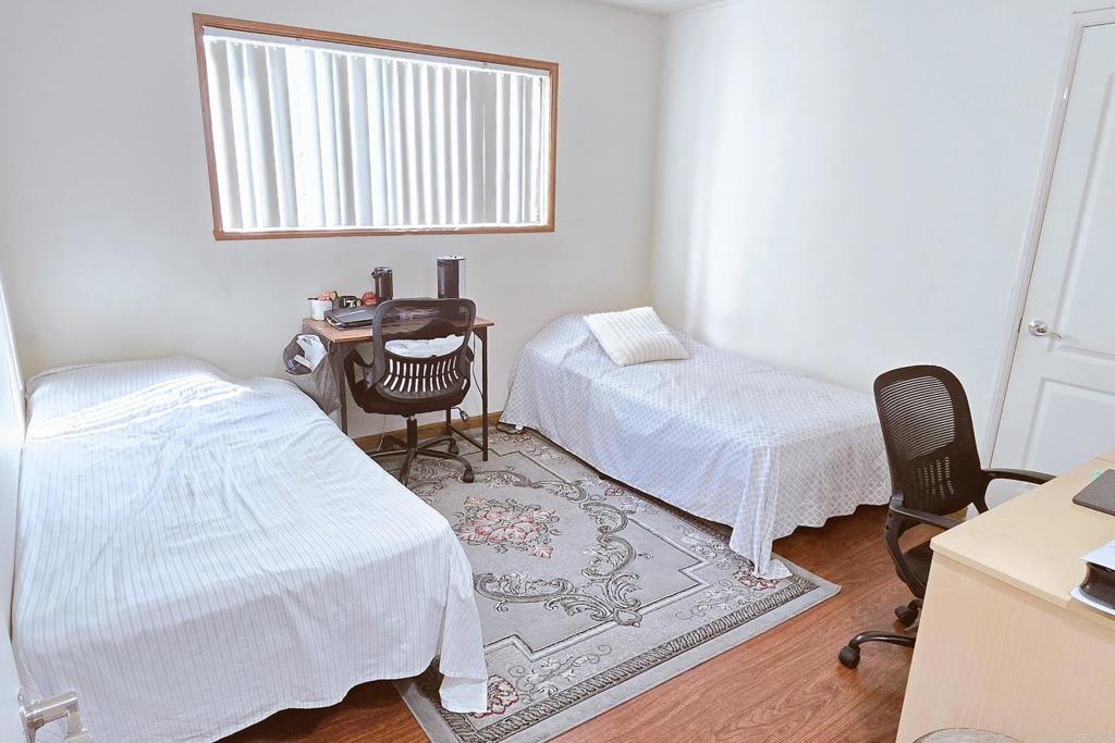 505 East Madison Avenue, Unit 70 El Cajon, CA 92020 - Photo 9 of 13 a bedroom with a bed and a chair