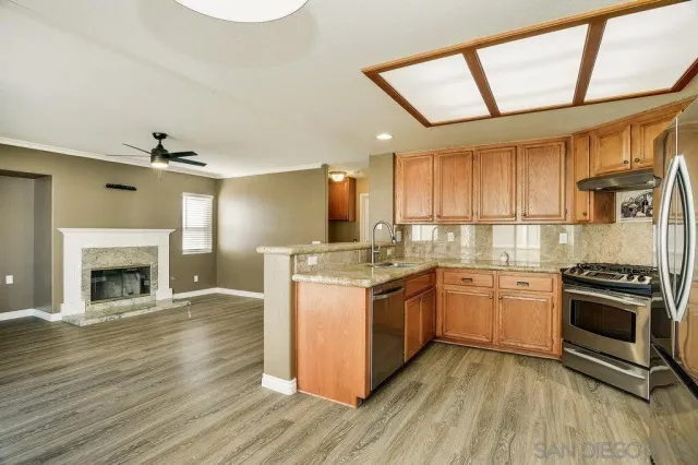 a kitchen with stainless steel appliances granite countertop a stove and a sink