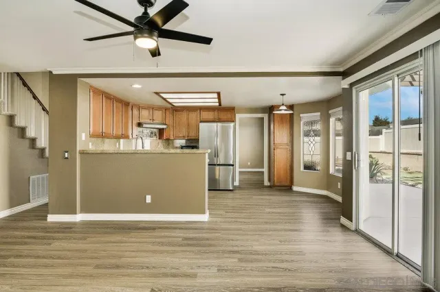a view of a kitchen with a refrigerator and a window