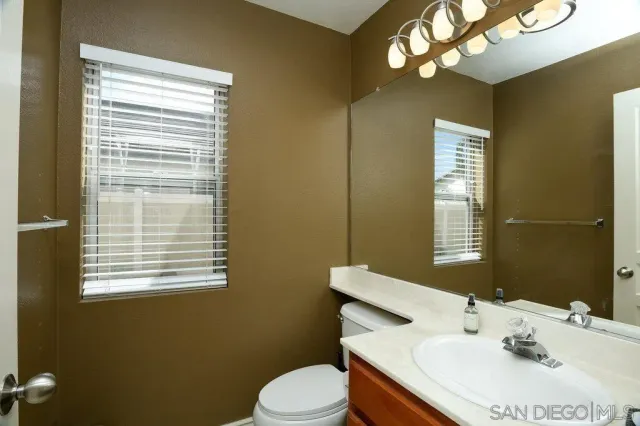 a bathroom with a sink a mirror and a toilet