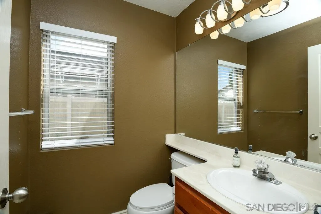 11212 Callio Way Lakeside, CA 92040 - Photo 19 of 50 a bathroom with a sink a mirror and a toilet