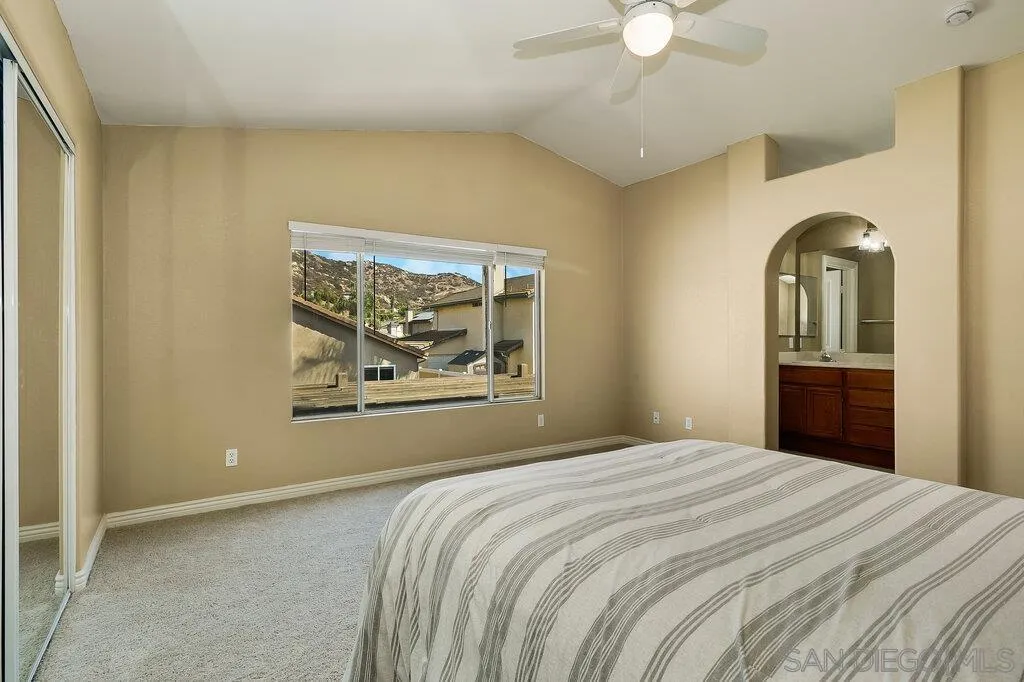 11212 Callio Way Lakeside, CA 92040 - Photo 22 of 50 a bedroom with a bed and a chandelier