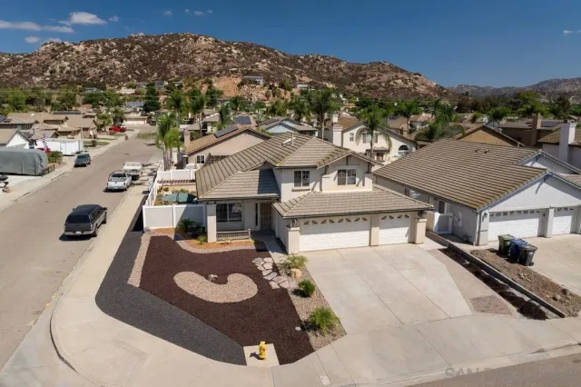 an aerial view of a house with a yard and balcony