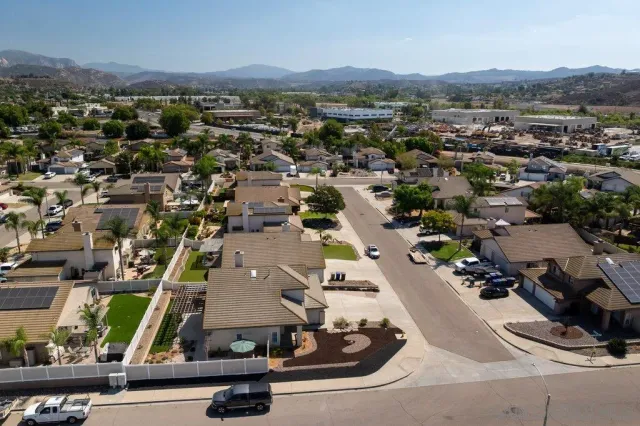 an aerial view of residential houses with outdoor space