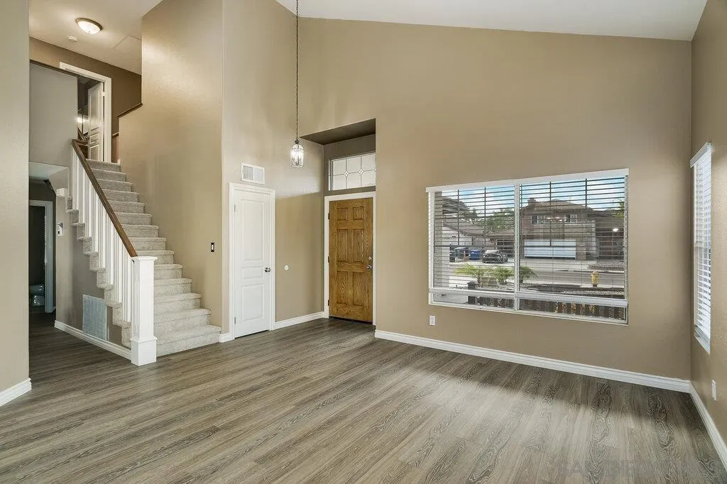 11212 Callio Way Lakeside, CA 92040 - Photo 5 of 50 a view of an empty room with wooden floor and a window