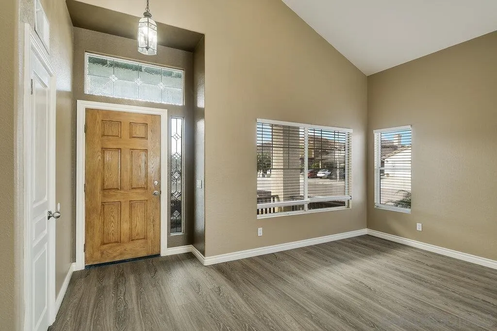 11212 Callio Way Lakeside, CA 92040 - Photo 6 of 50 an empty room with wooden floor and windows