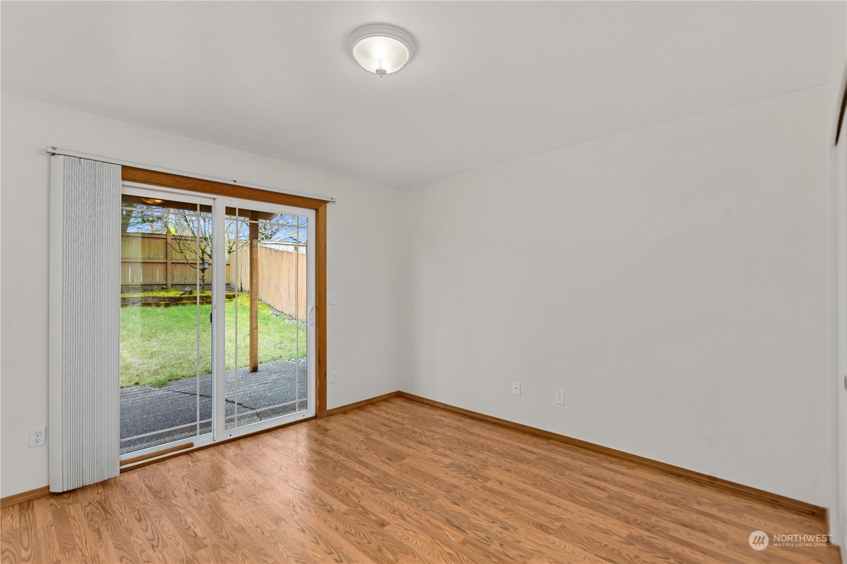 24216 13th Place West Bothell, WA 98021 - Photo 34 of 37 a view of an empty room with wooden floor and a window