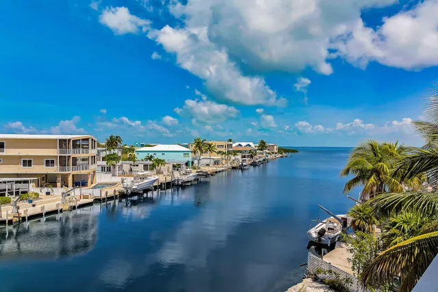a view of a lake with lawn chairs