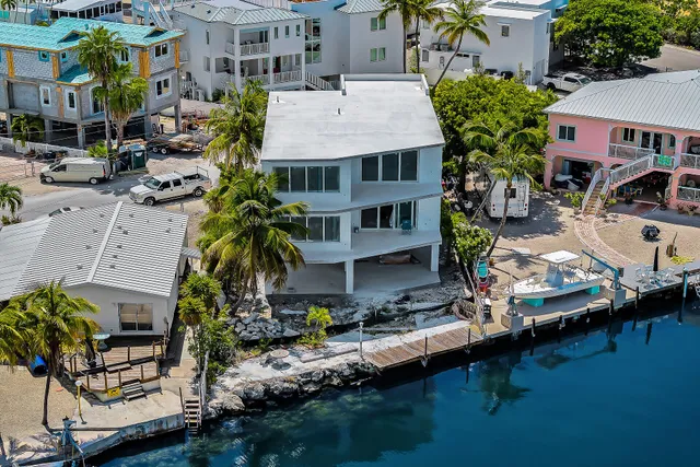 an aerial view of multiple houses with yard