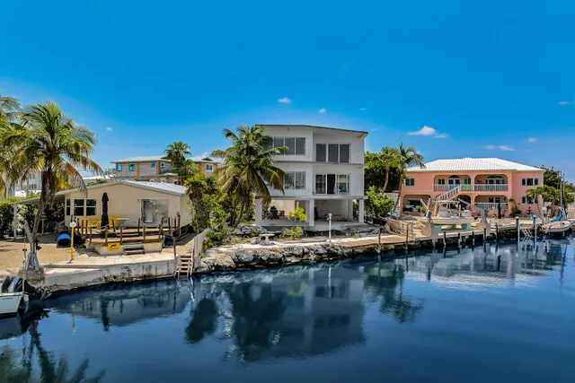 a view of house with swimming pool and outdoor seating