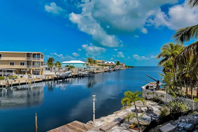 a view of a lake with lawn chairs