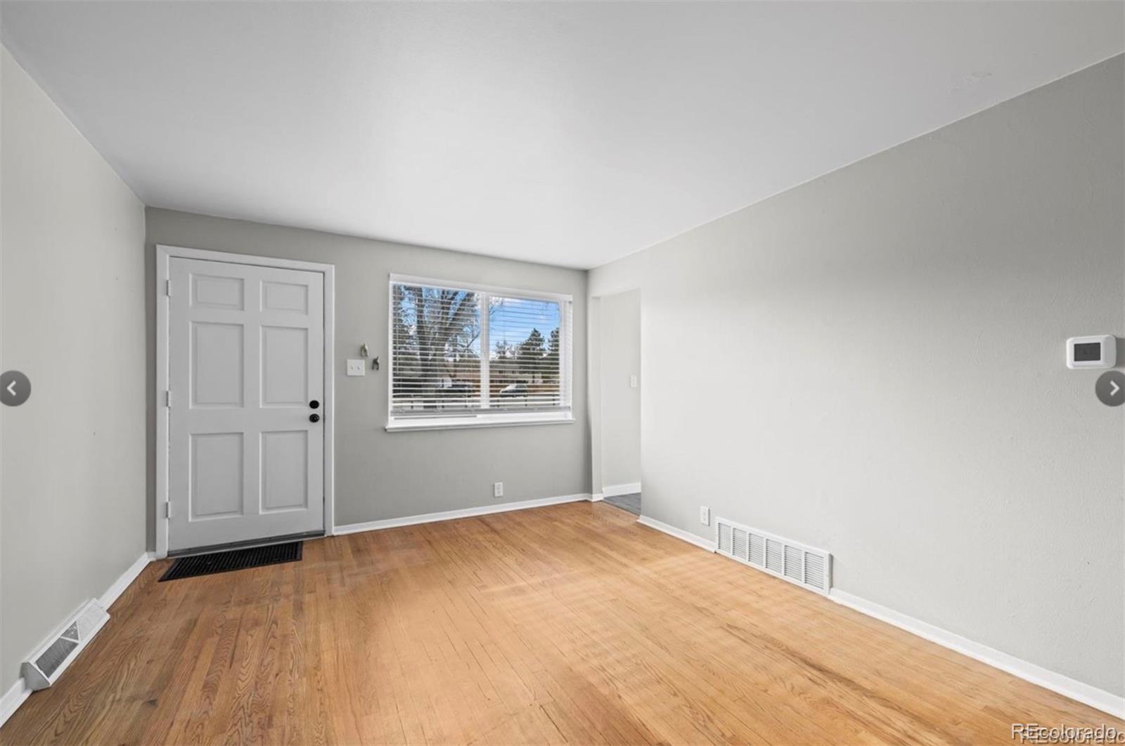8795 West 46th Avenue Wheat Ridge, CO 80033 - Photo 11 of 12 a view of empty room with wooden floor
