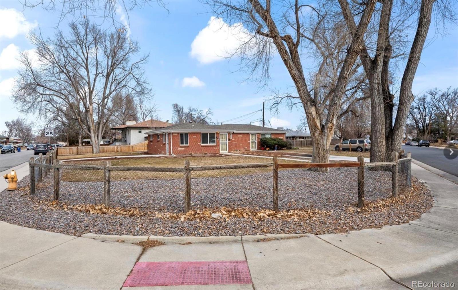 8795 West 46th Avenue Wheat Ridge, CO 80033 - Photo 3 of 12 a front view of a house with garden