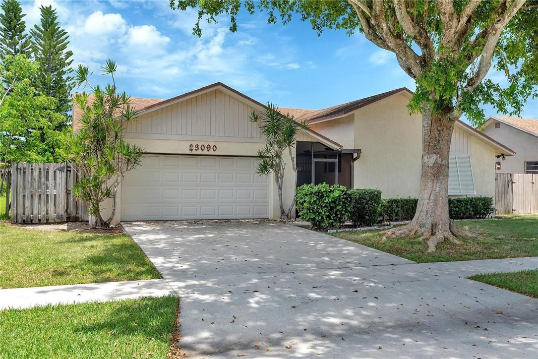 23090 Southwest 56th Avenue Boca Raton, FL 33433 - Photo 1 of 49 a view of a house with a yard plants and large tree
