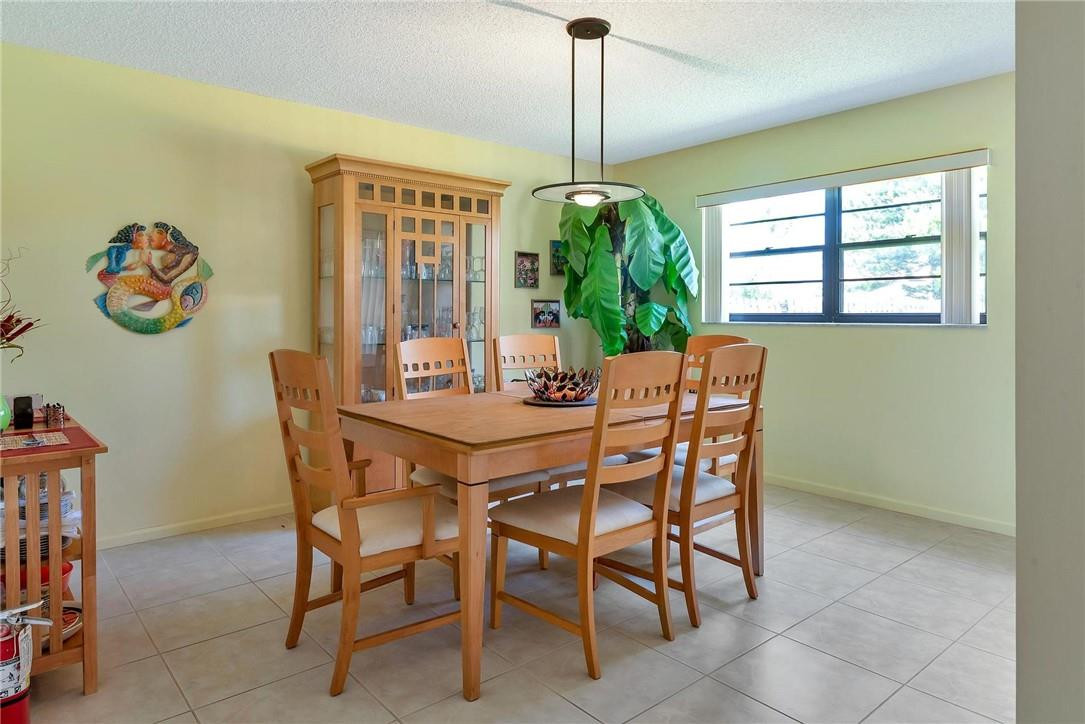23090 Southwest 56th Avenue Boca Raton, FL 33433 - Photo 20 of 49 a dining room with furniture a chandelier and window