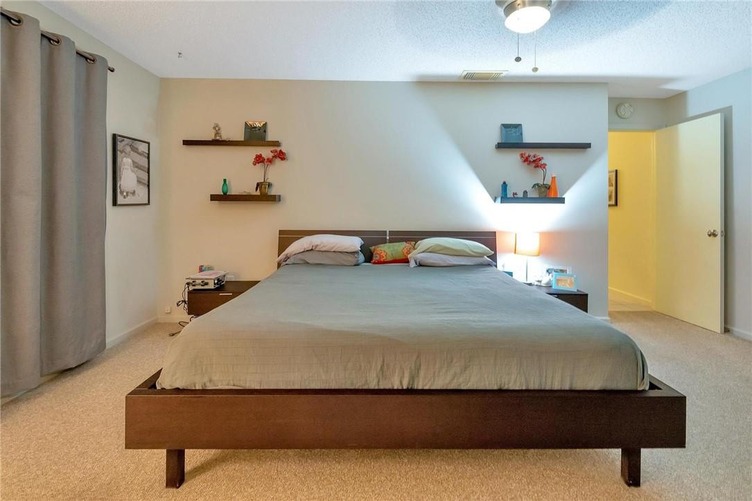 23090 Southwest 56th Avenue Boca Raton, FL 33433 - Photo 36 of 49 a bedroom with a bed and wooden floor
