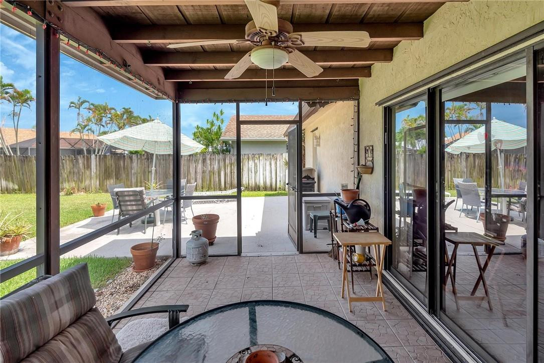 23090 Southwest 56th Avenue Boca Raton, FL 33433 - Photo 40 of 49 a dining room with furniture water view and a floor to ceiling window