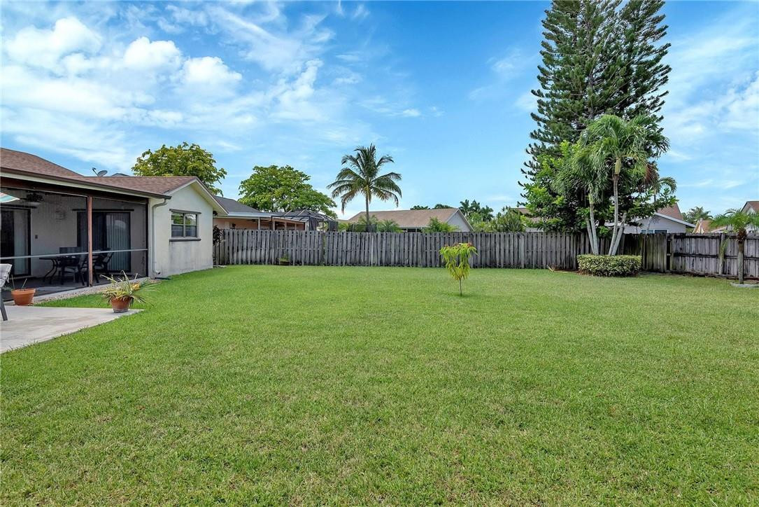 23090 Southwest 56th Avenue Boca Raton, FL 33433 - Photo 44 of 49 a view of a house with a yard porch and a tree