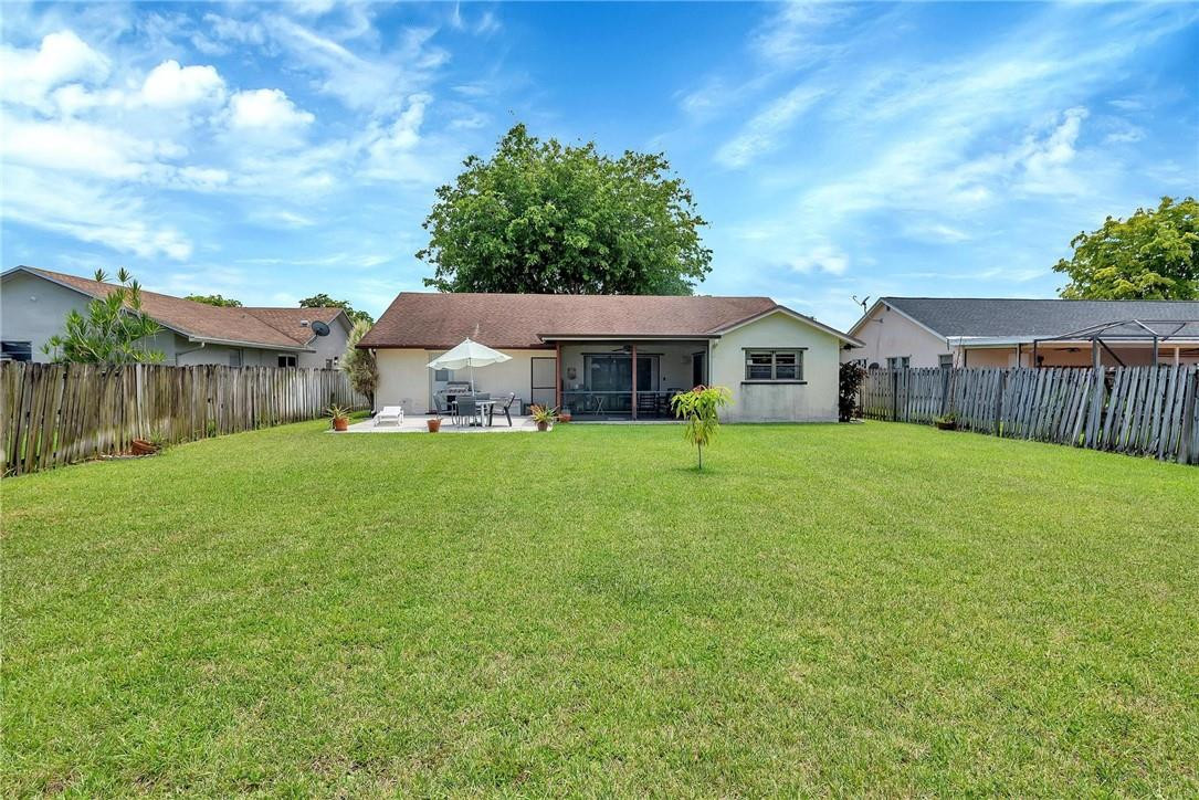 23090 Southwest 56th Avenue Boca Raton, FL 33433 - Photo 46 of 49 a view of a house with a big yard and large tree