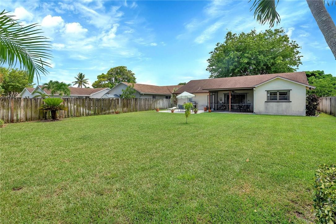 23090 Southwest 56th Avenue Boca Raton, FL 33433 - Photo 47 of 49 a view of a house with a yard