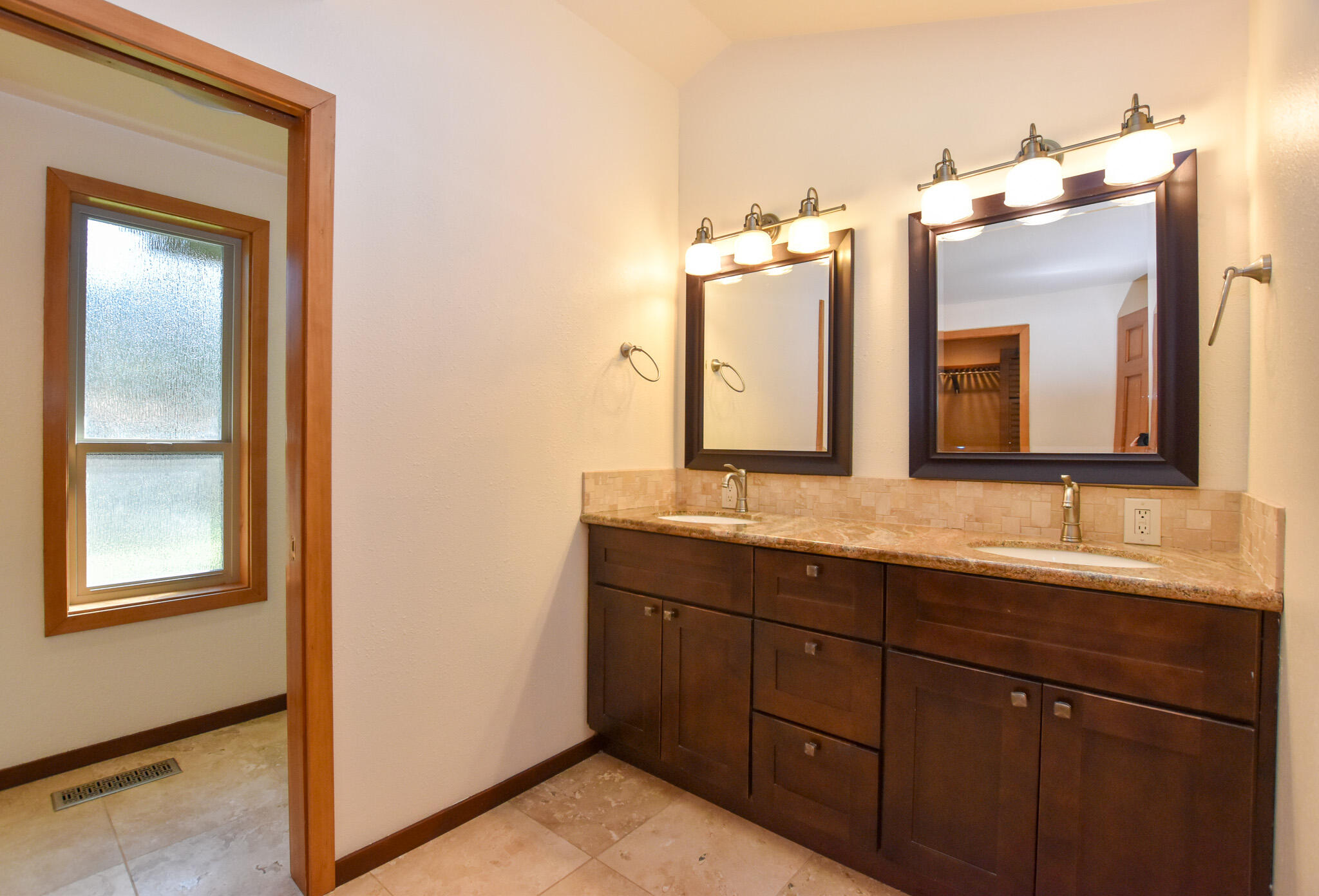 64730 Sylvan Loop Bend, OR 97701 - Photo 11 of 46 a bathroom with a double vanity sink and a mirror
