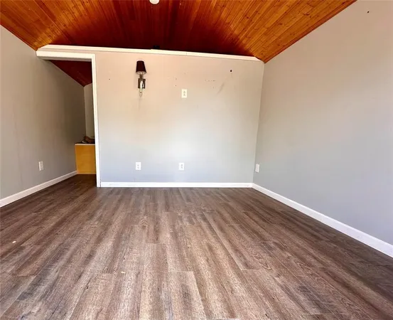 a view of a room with wooden floor