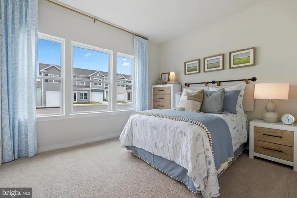 a spacious bedroom with a bed and a window