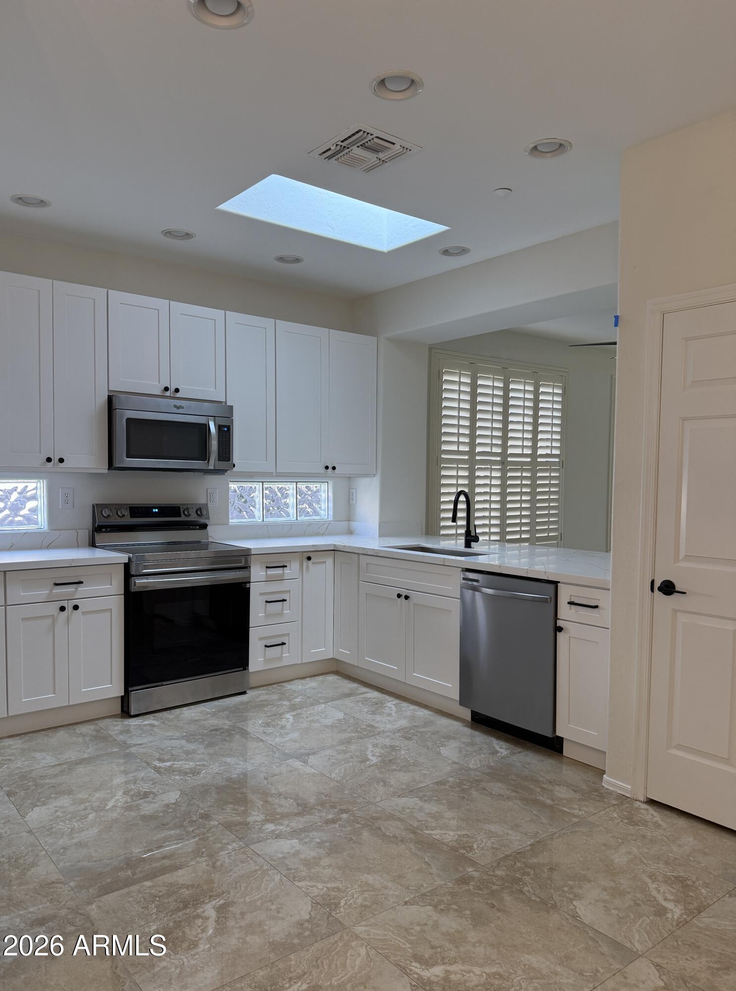 41915 North Crooked Stick Road Anthem, AZ 85086 - Photo 3 of 29 a kitchen with stainless steel appliances granite countertop a stove sink and cabinets