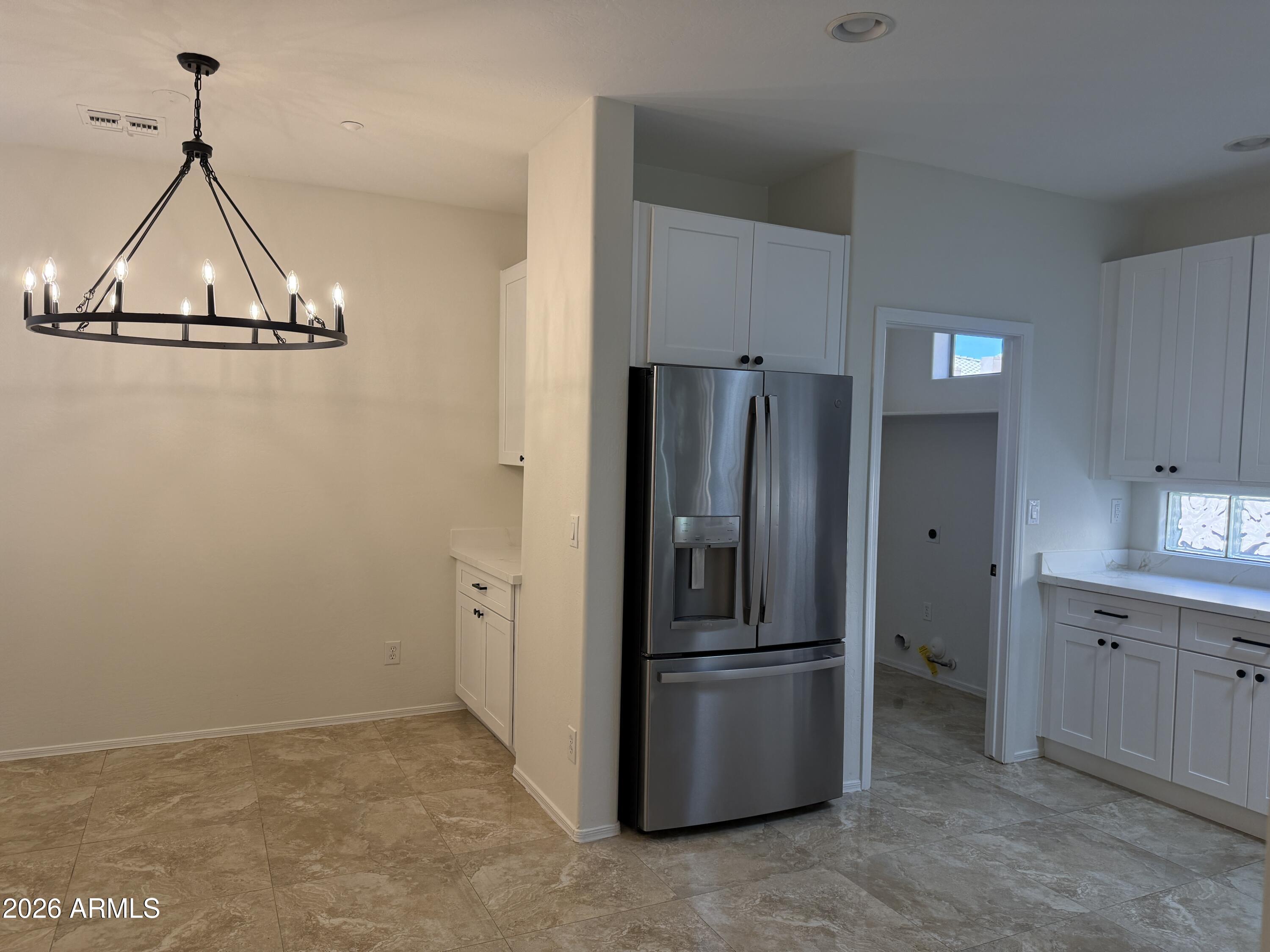 41915 North Crooked Stick Road Anthem, AZ 85086 - Photo 6 of 29 a kitchen with stainless steel appliances a refrigerator and cabinets