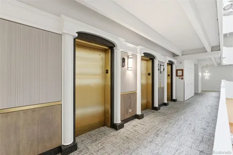 a view of a hallway with wooden shelves