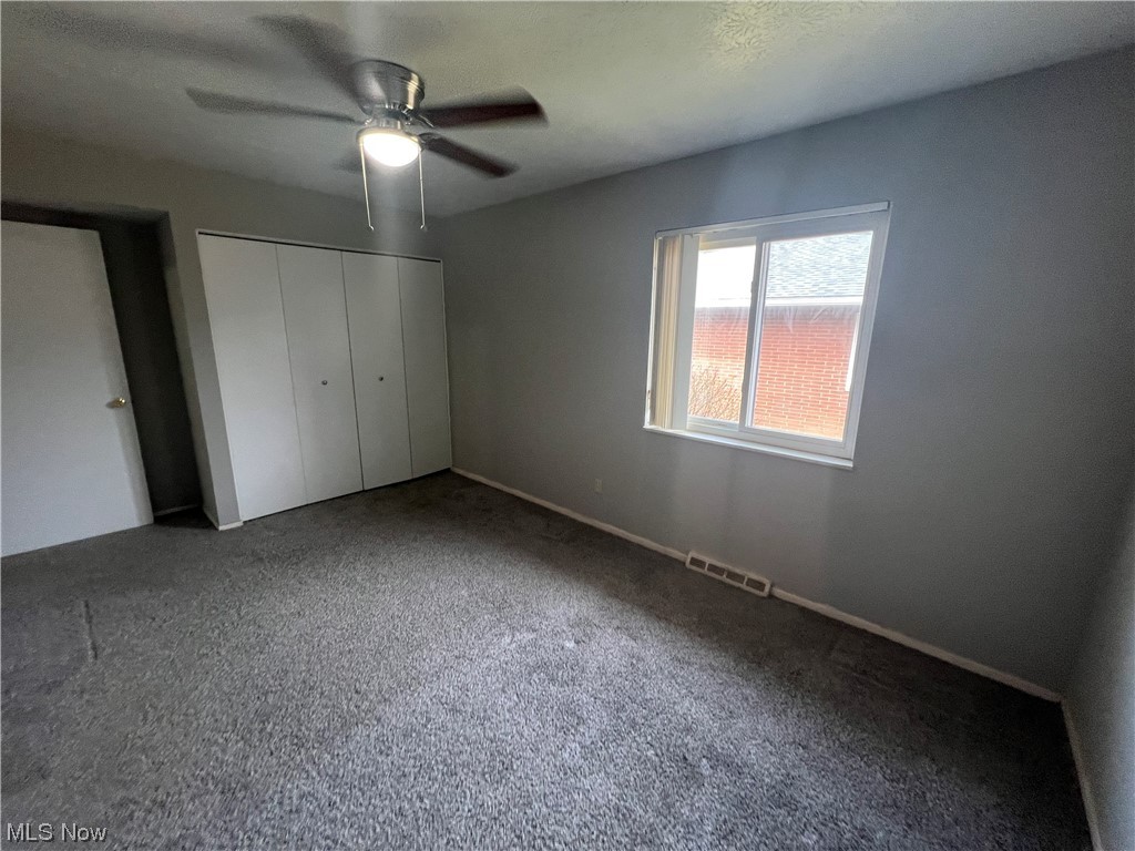 5651 Broadview Road, Unit C 07 Cleveland, OH 44134 - Photo 11 of 15 Unfurnished bedroom featuring a closet, dark colored carpet, and ceiling fan