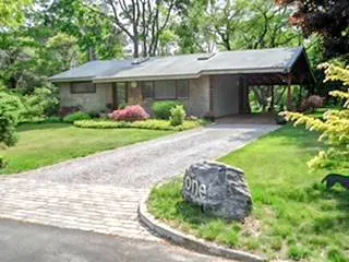 a front view of a house with garden